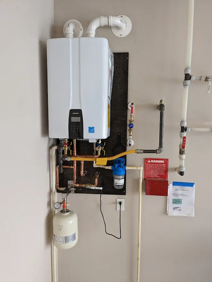 Professional plumber installing copper piping in a Shively home